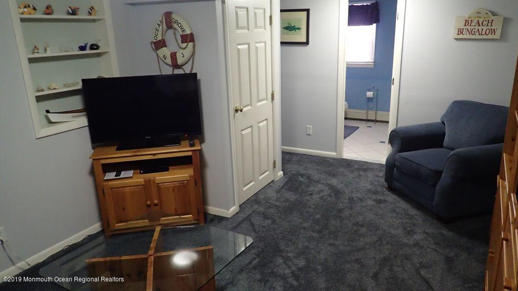 20 McClintock Street Ocean Grove, NJ 07756 - Photo 13 of 19 a living room with furniture and a flat screen tv