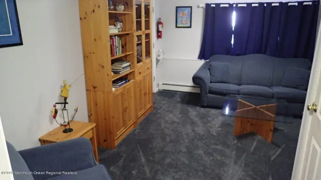 a living room with furniture and a book shelf