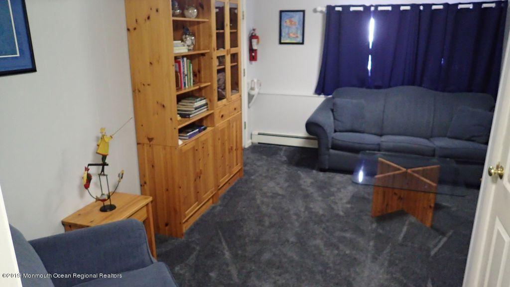 20 McClintock Street Ocean Grove, NJ 07756 - Photo 14 of 19 a living room with furniture and a book shelf