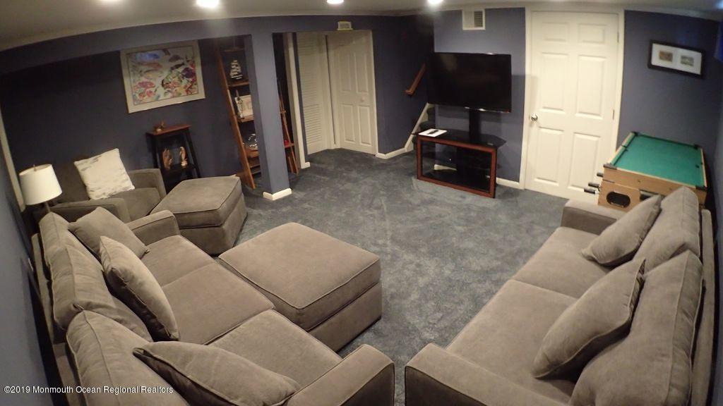 20 McClintock Street Ocean Grove, NJ 07756 - Photo 16 of 19 a living room with furniture and a flat screen tv