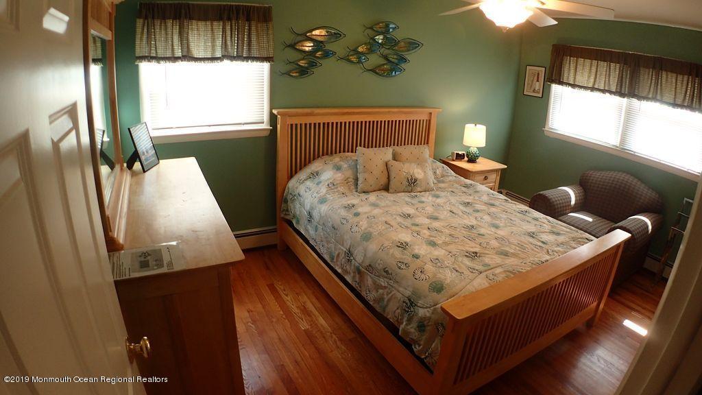 20 McClintock Street Ocean Grove, NJ 07756 - Photo 8 of 19 a bed sitting in a bedroom next to a window