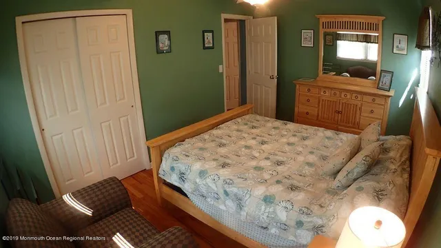 a bedroom with a bed and a mirror
