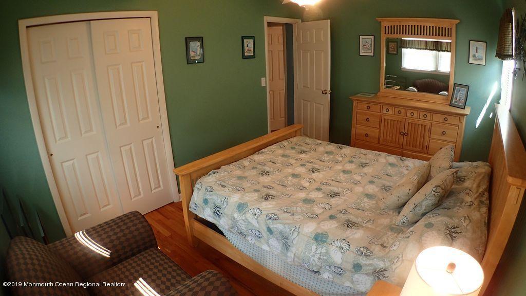 20 McClintock Street Ocean Grove, NJ 07756 - Photo 9 of 19 a bedroom with a bed and a mirror