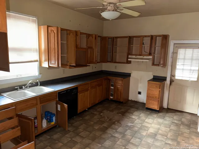 a kitchen with a sink and cabinets