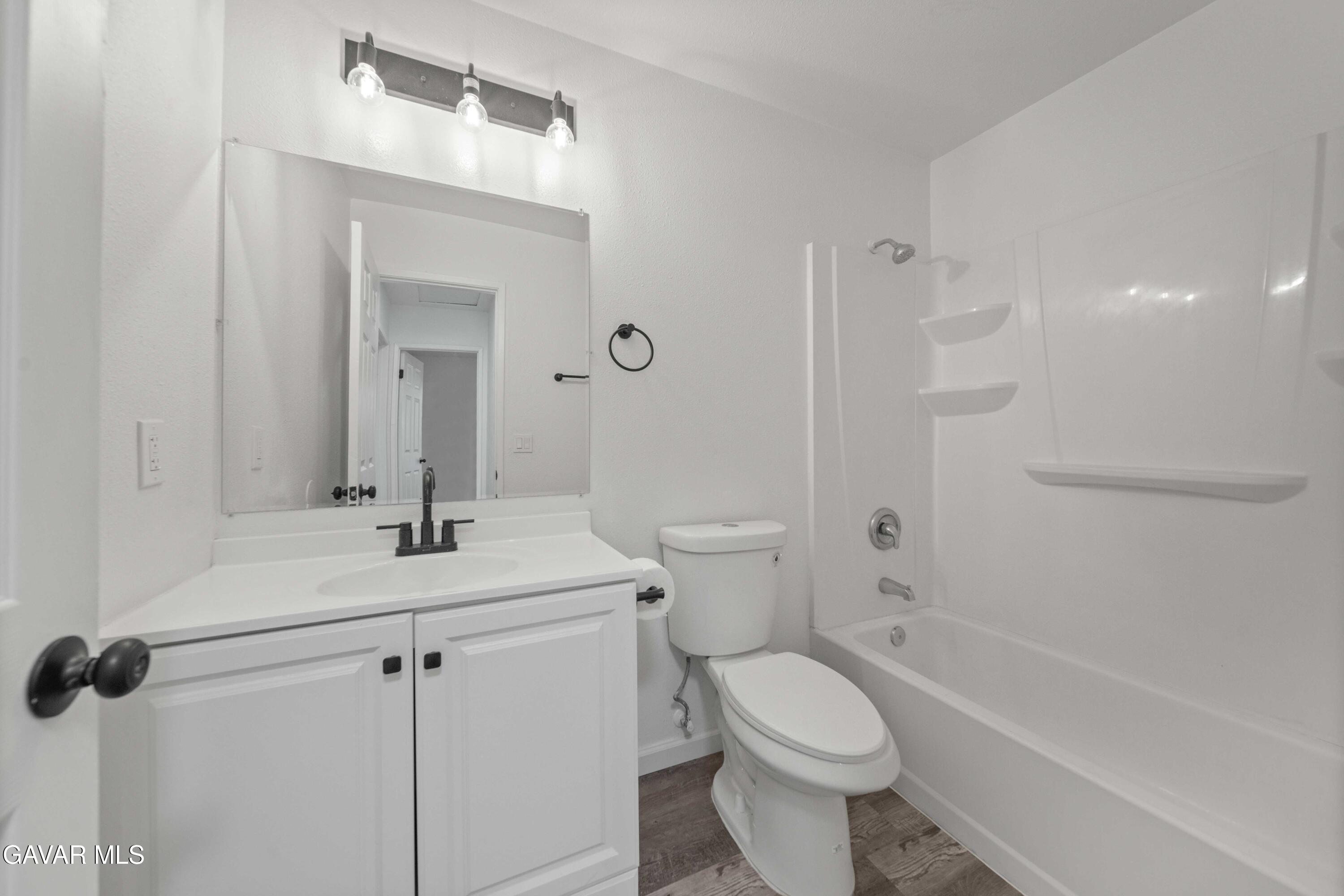 40054 Ridgemist Street Palmdale, CA 93591 - Photo 12 of 21 a bathroom with a sink a toilet and shower
