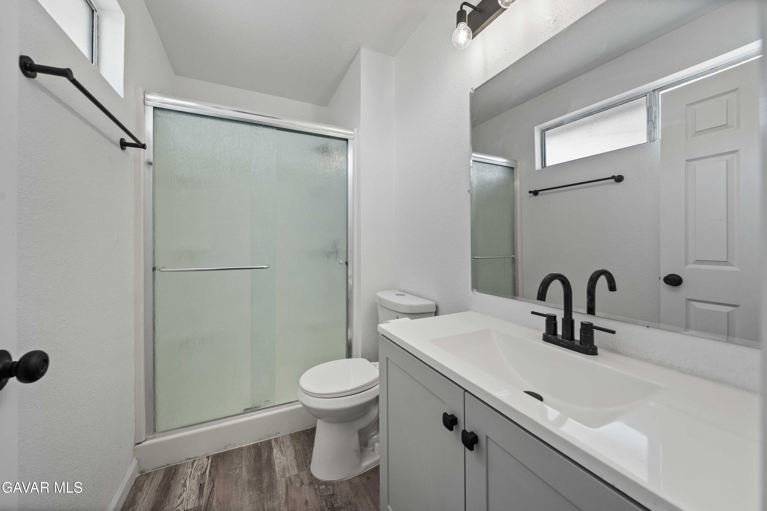 40054 Ridgemist Street Palmdale, CA 93591 - Photo 15 of 21 a bathroom with a sink toilet and shower