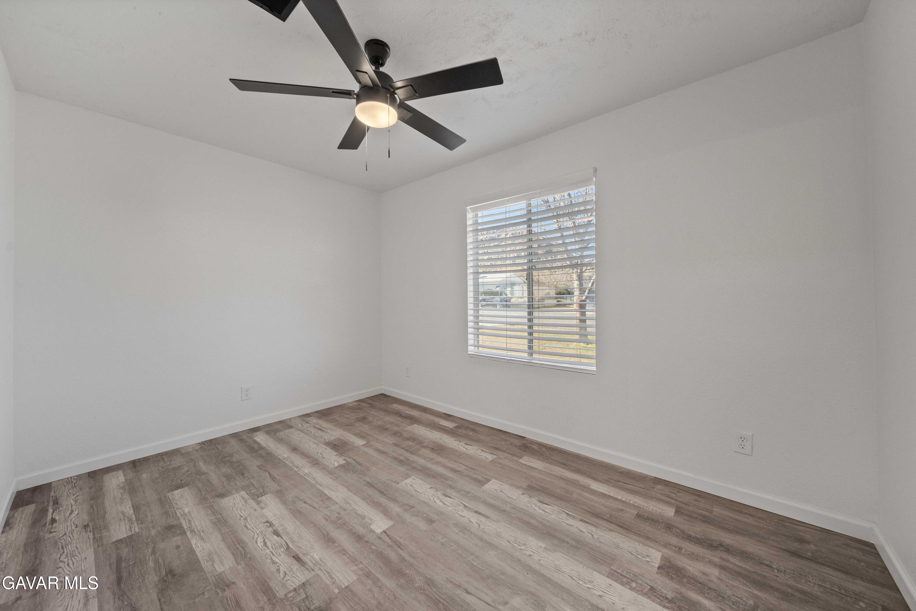 40054 Ridgemist Street Palmdale, CA 93591 - Photo 18 of 21 an empty room with a window and a fan