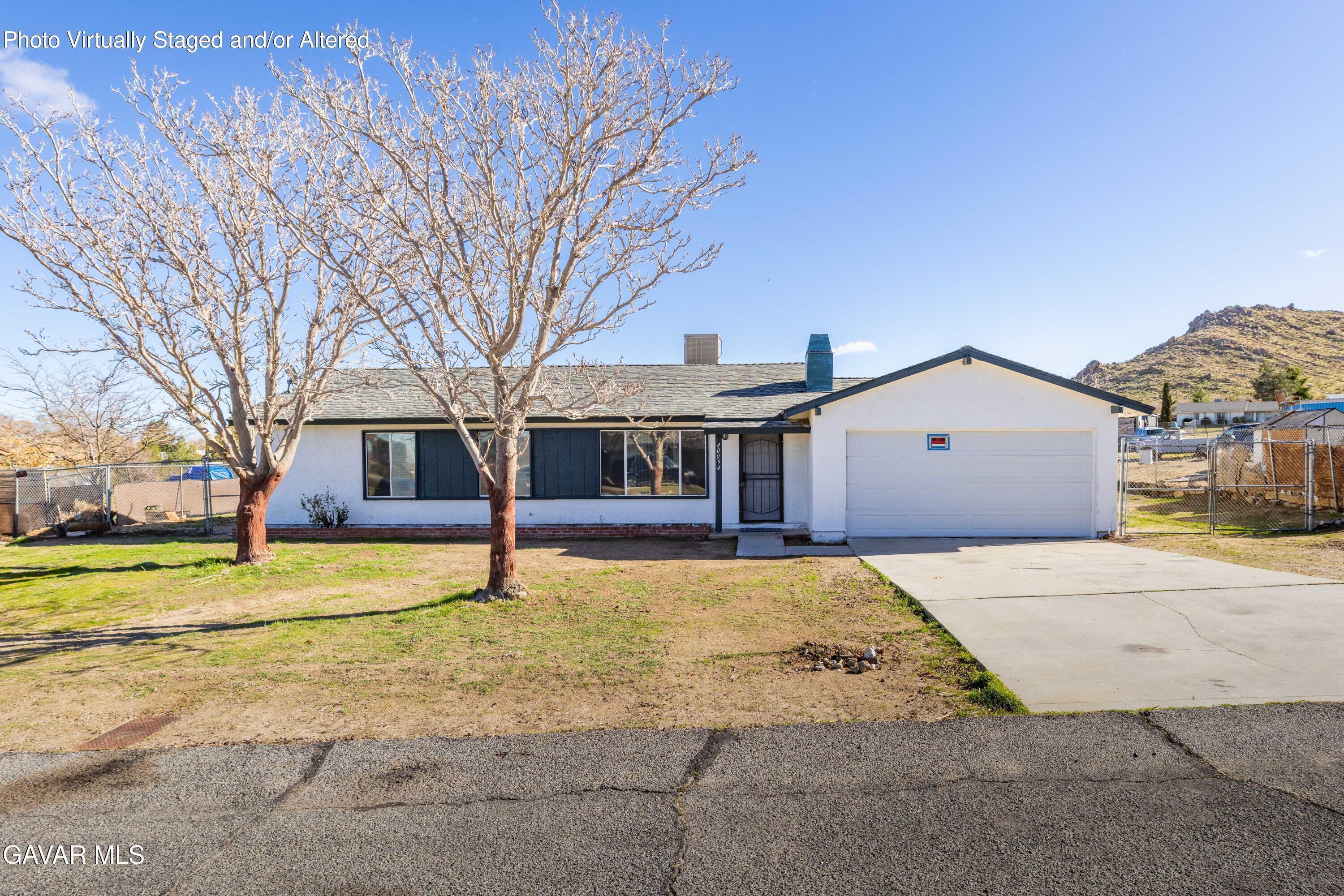 40054 Ridgemist Street Palmdale, CA 93591 - Photo 3 of 21 a front view of a house with a yard