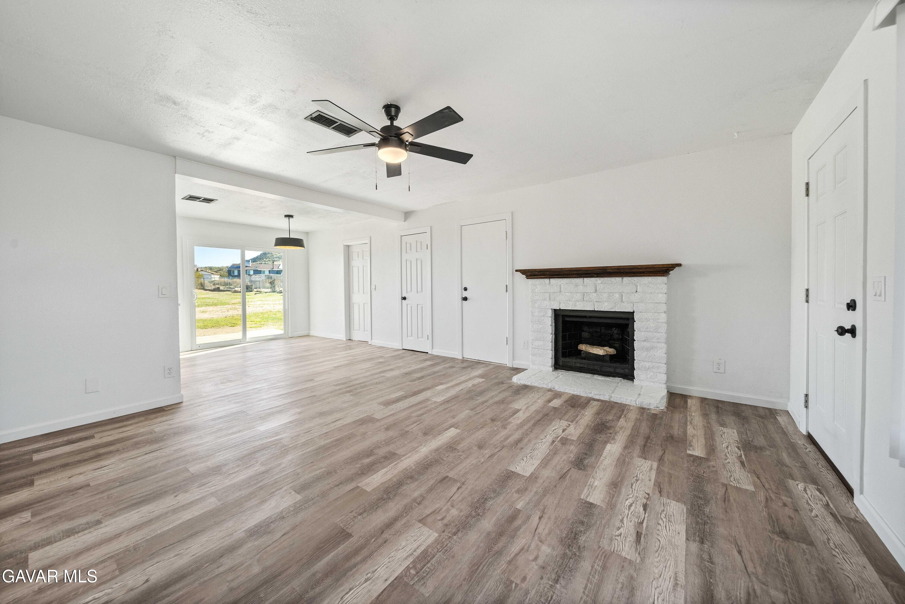 40054 Ridgemist Street Palmdale, CA 93591 - Photo 5 of 21 a view of an empty room with a fireplace