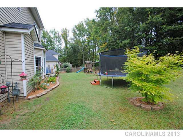 3228 Williams Station Road Matthews, NC 28105 - Photo 15 of 16 a backyard of a house with table and chairs