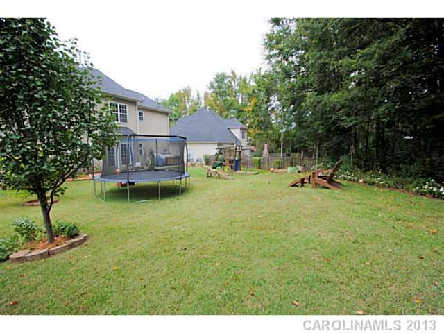 3228 Williams Station Road Matthews, NC 28105 - Photo 16 of 16 a view of a house with a backyard and a tree