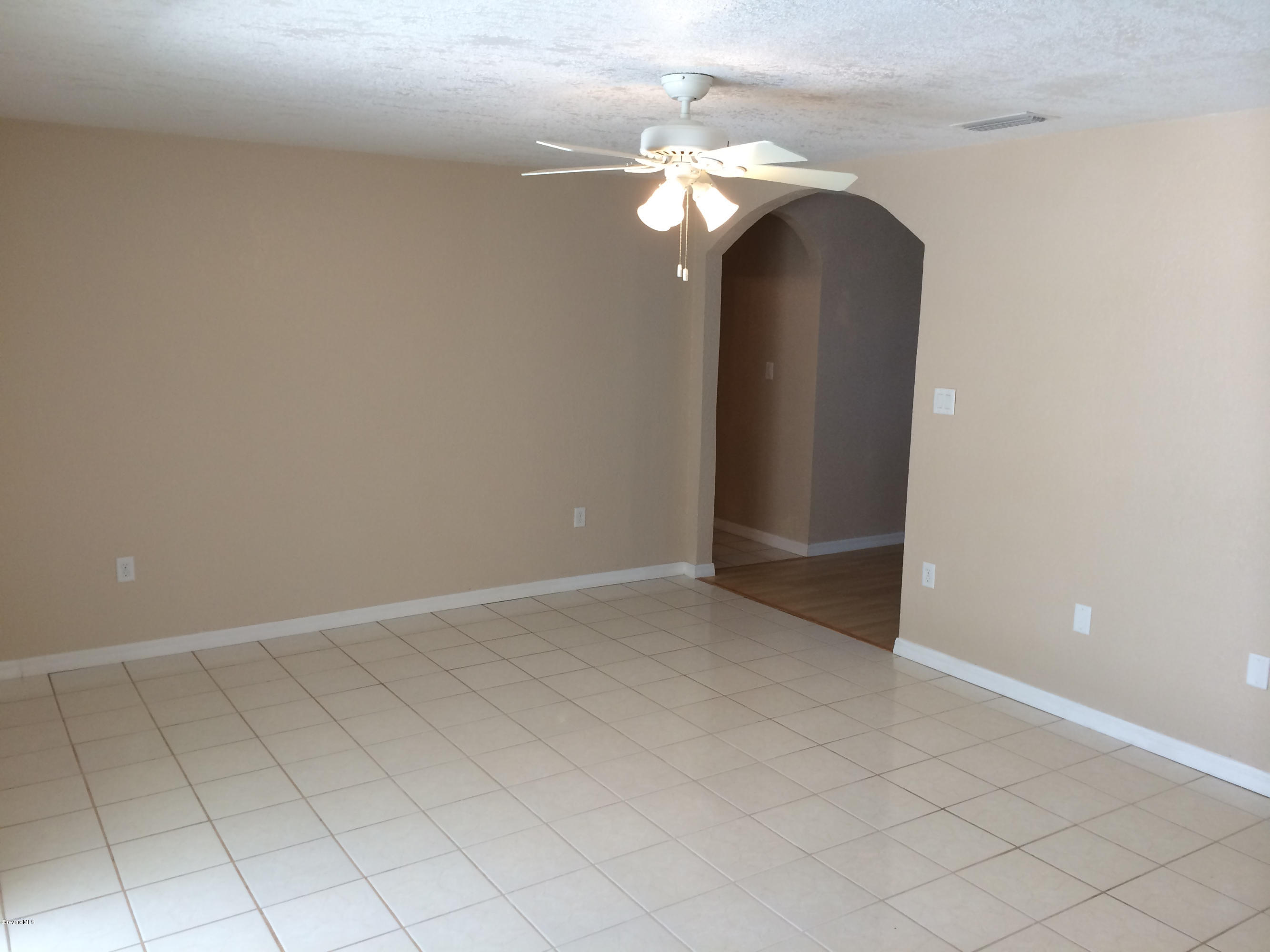 6965 Bryant Road Cocoa, FL 32927 - Photo 5 of 12 an empty room with wooden floor