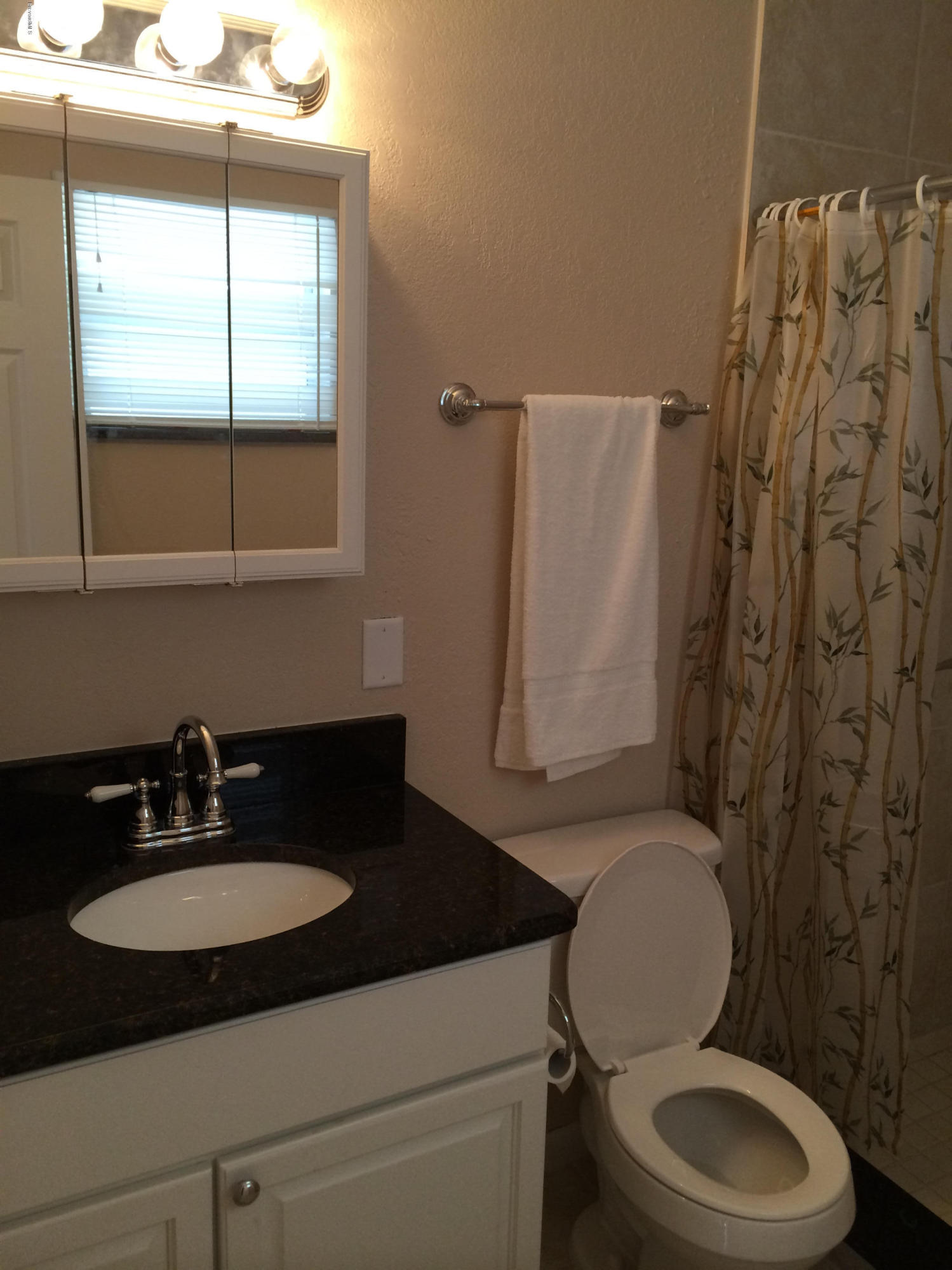 6965 Bryant Road Cocoa, FL 32927 - Photo 6 of 12 a bathroom with a sink toilet and shower