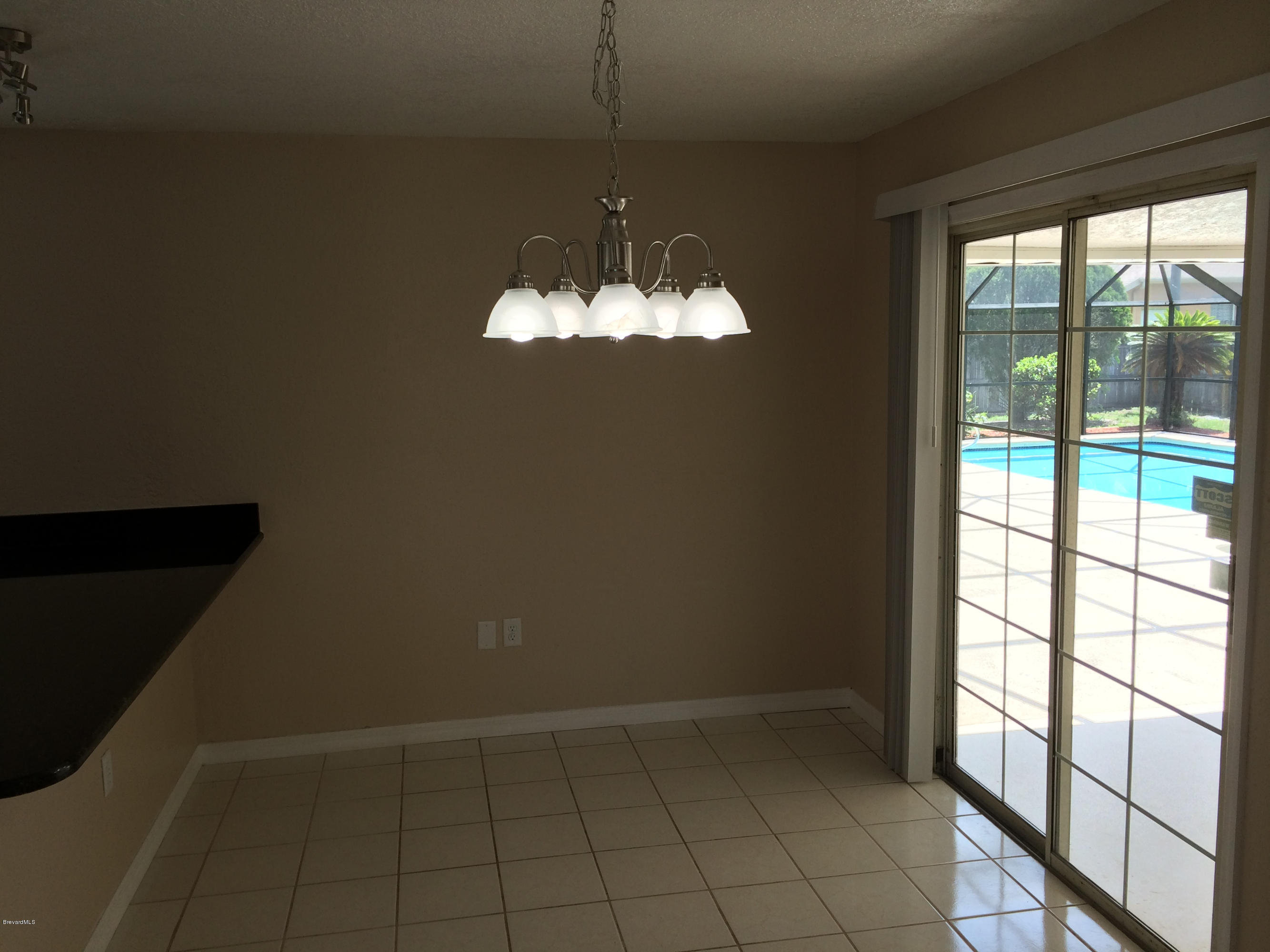 6965 Bryant Road Cocoa, FL 32927 - Photo 9 of 12 wooden floor in an empty room with a window