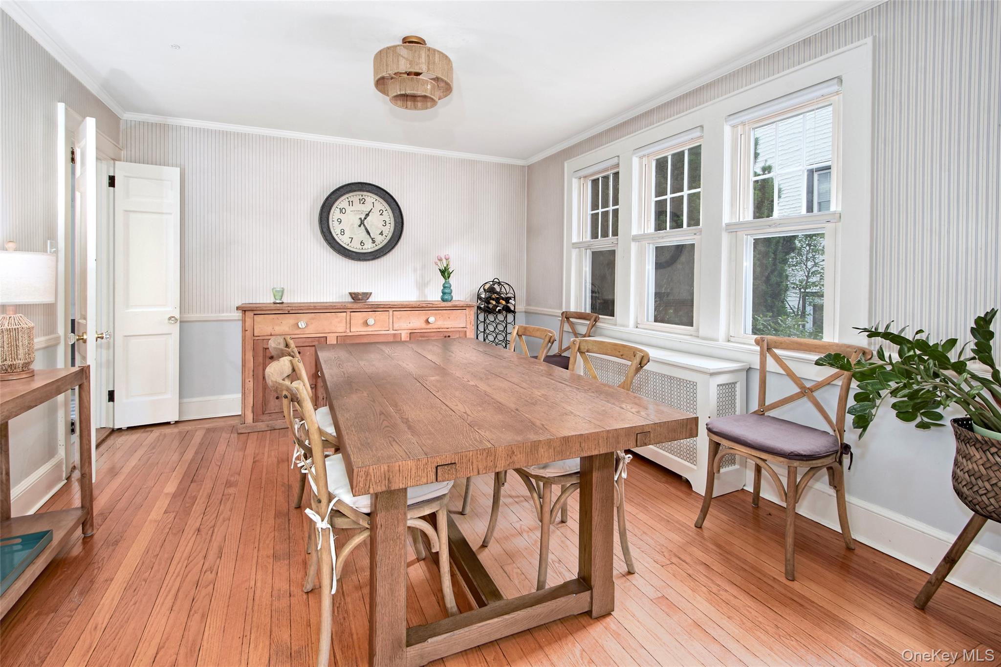 9 Fenton Street Rye, NY 10580 - Photo 8 of 22 A bright and inviting dining room designed for both everyday living and entertaining. Oversized windows fill the space with natural light, highlighting the warm hardwood floors and creating a welcoming atmosphere.