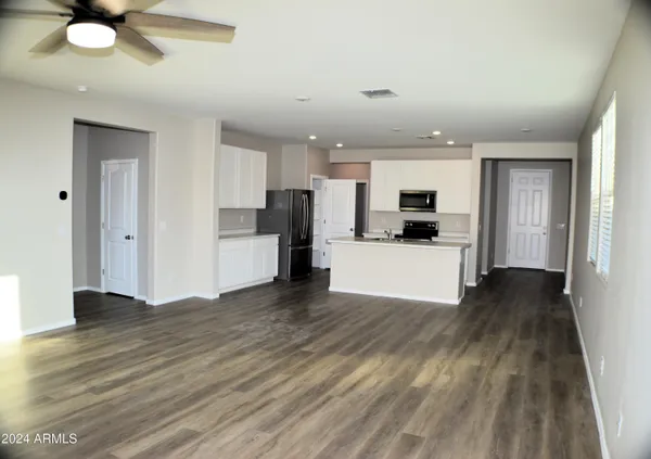 a view of a kitchen with a sink and a refrigerator