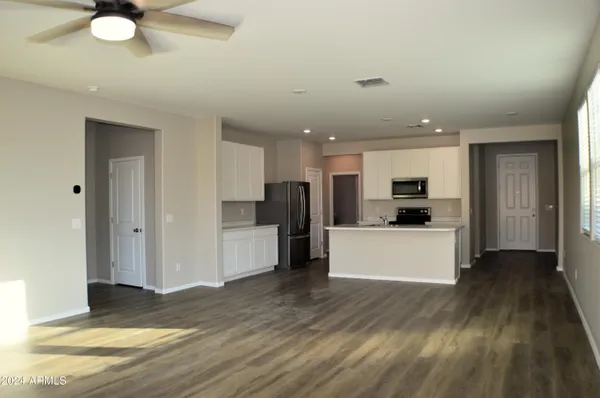a view of kitchen with kitchen island sink and refrigerator