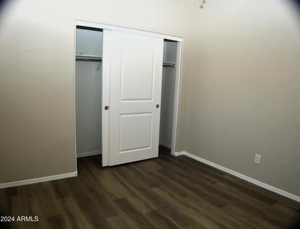 an empty room with wooden floor