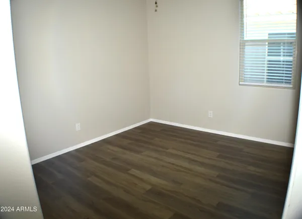 a view of a hallway with a table and chandelier