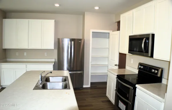 a kitchen with a refrigerator stove and microwave