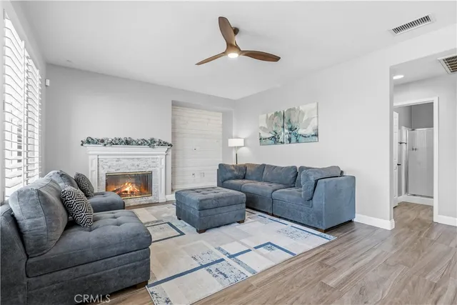 a living room with furniture a fireplace and a window