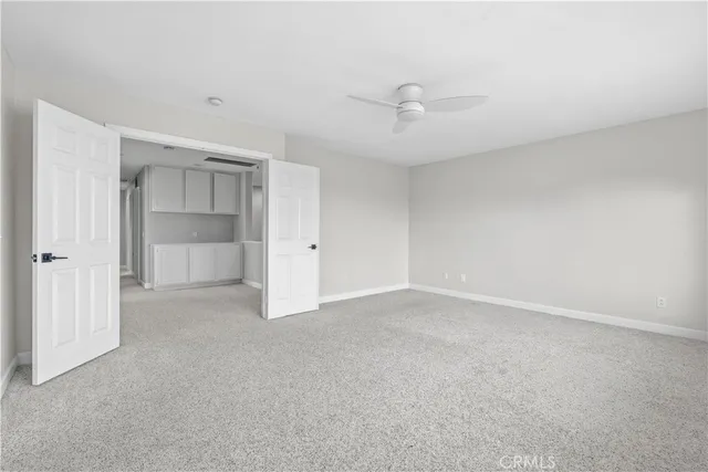 a view of an empty room with a cabinet