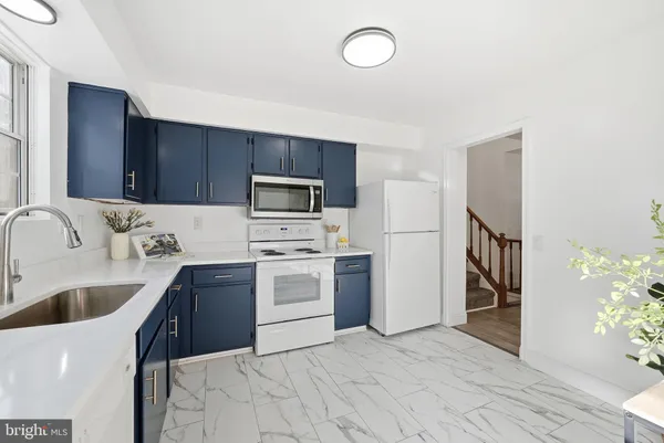 a kitchen with a sink stainless steel appliances and cabinets