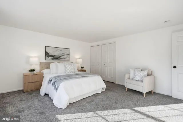 a bedroom with two beds and a large window