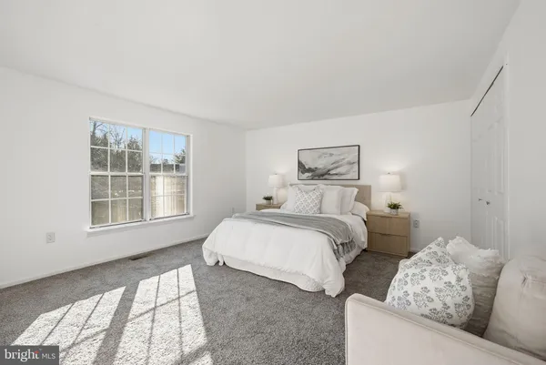 a bedroom with two beds and a large window