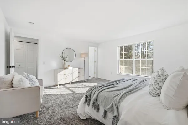 a bedroom with a bed and window