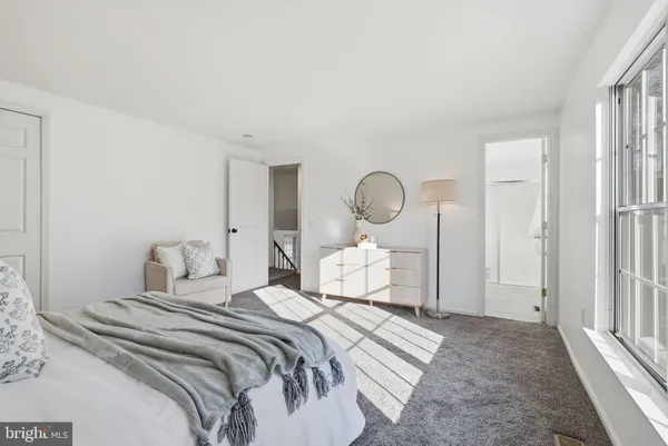 a bedroom with a bed and painting on the wall