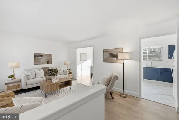 a living room with furniture a rug and a table