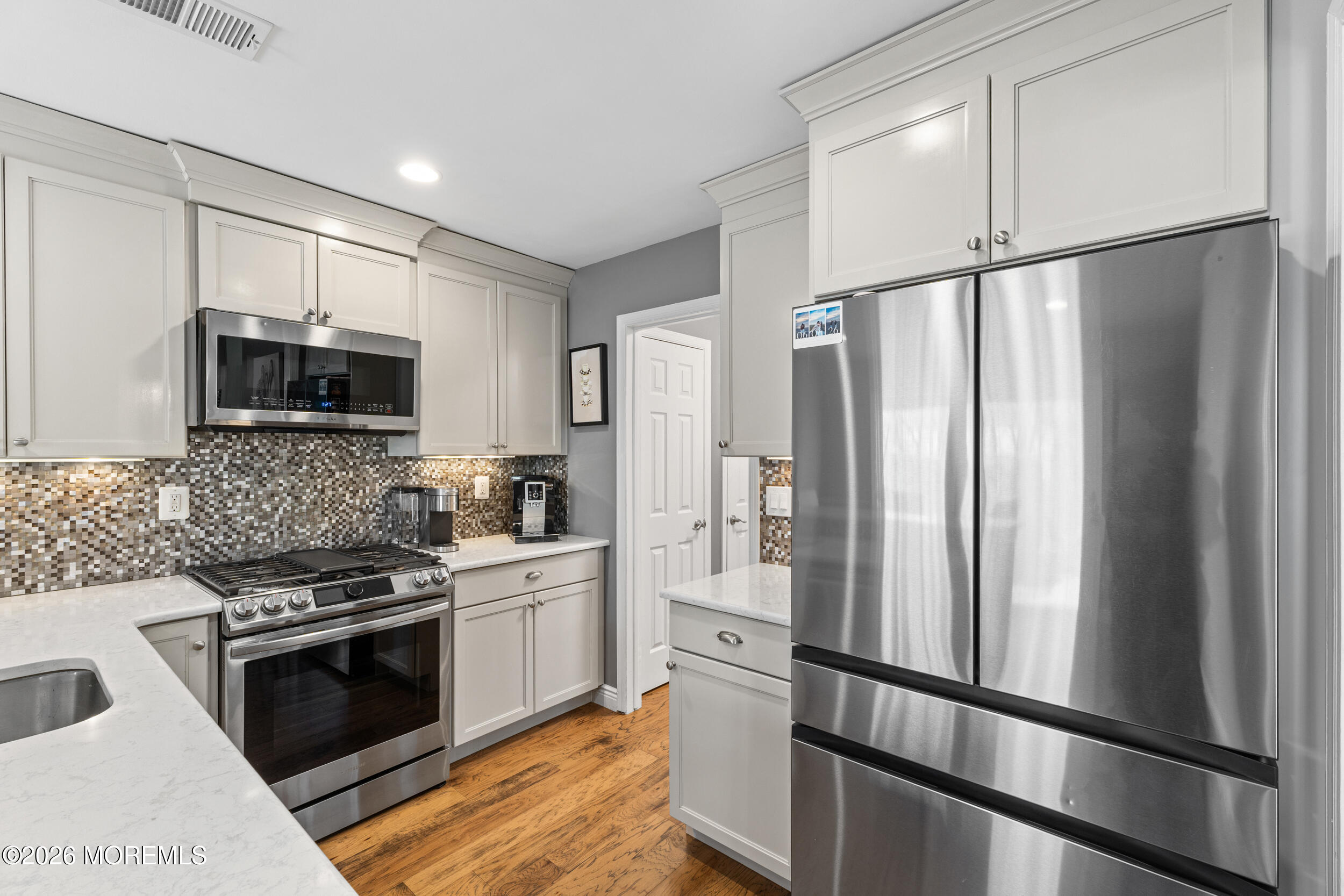 126 Wainwright Drive Old Bridge, NJ 07747 - Photo 13 of 54 a kitchen with stainless steel appliances a refrigerator stove and microwave