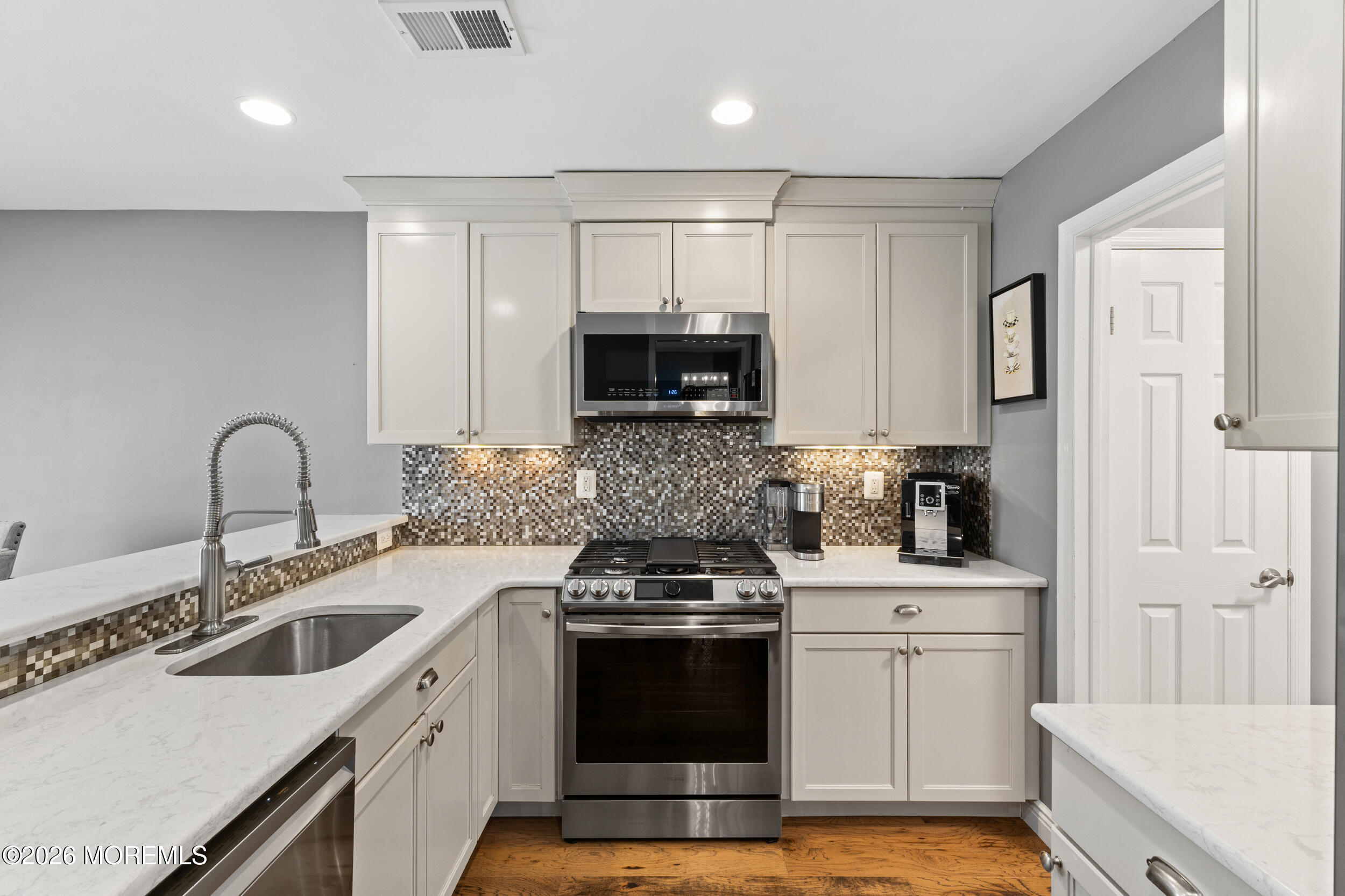 126 Wainwright Drive Old Bridge, NJ 07747 - Photo 14 of 54 a kitchen with a sink stove and cabinets