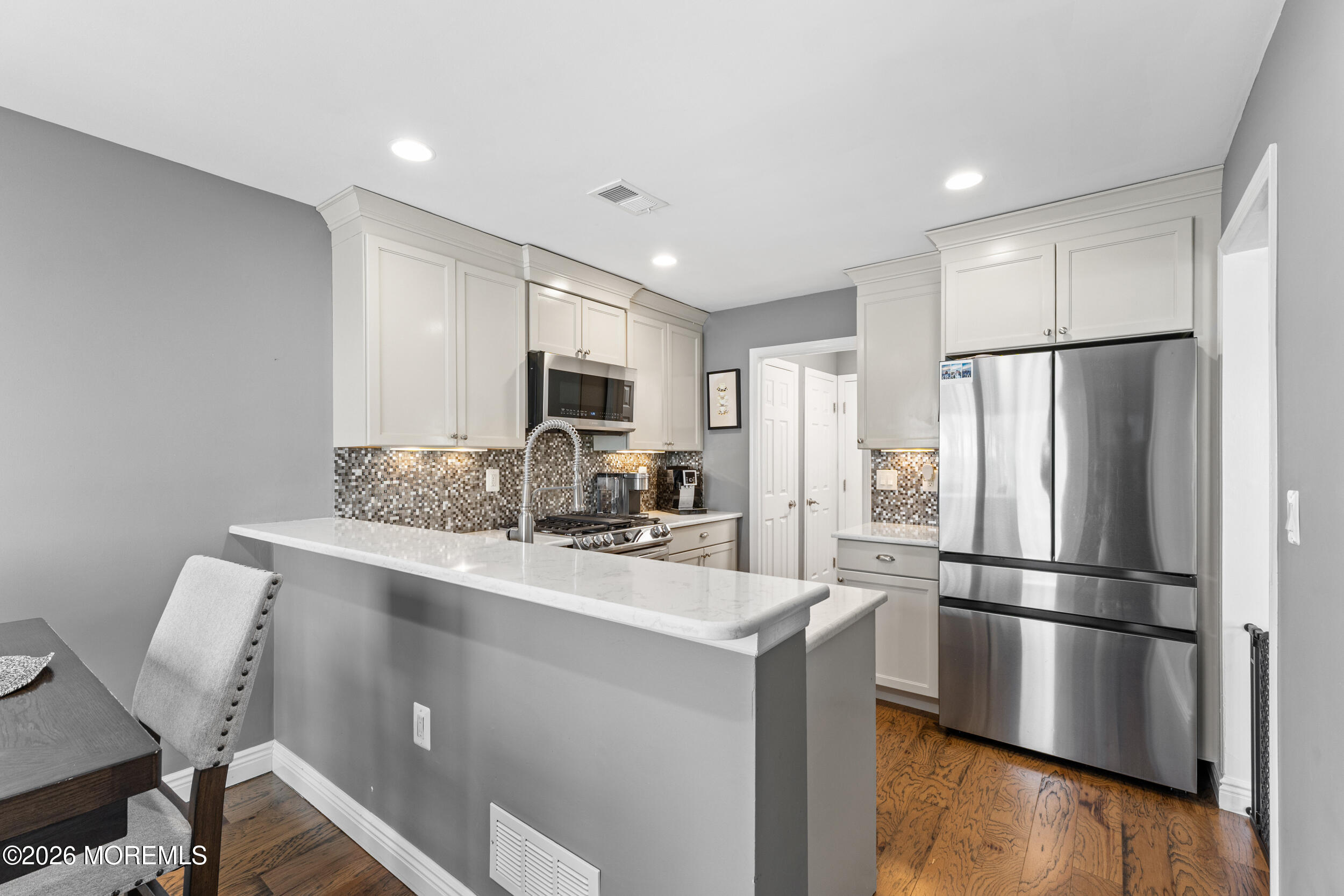 126 Wainwright Drive Old Bridge, NJ 07747 - Photo 18 of 54 a kitchen with stainless steel appliances a refrigerator sink stove microwave and cabinets