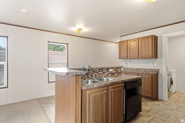 2875 North Hill Field Road, Unit 62 Layton, UT 84041 - Photo 15 of 34 Kitchen featuring an L-shaped counter with a dual basin sink, integrated dishwasher, and wood-finish cabinetry