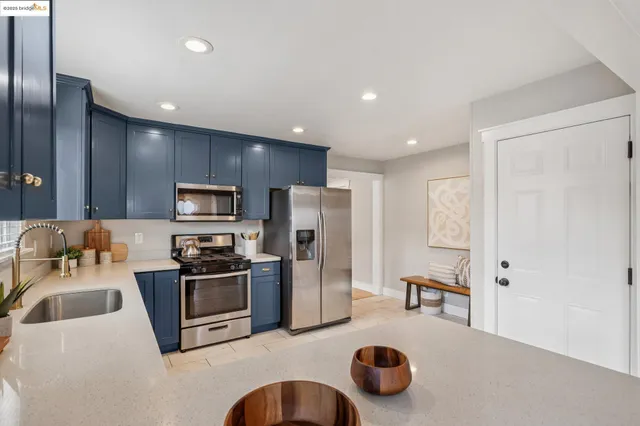 a kitchen with a sink stove top oven and cabinets