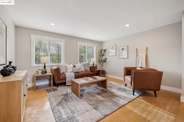 a living room with furniture a large window and a couch