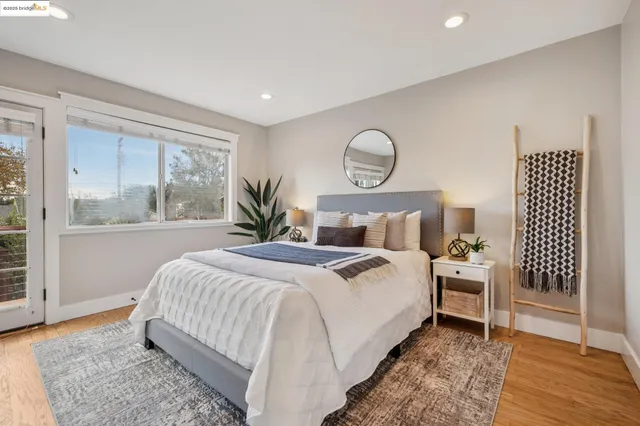 a bedroom with a large bed and a potted plant