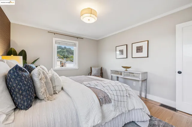 a bedroom with a bed and a potted plant