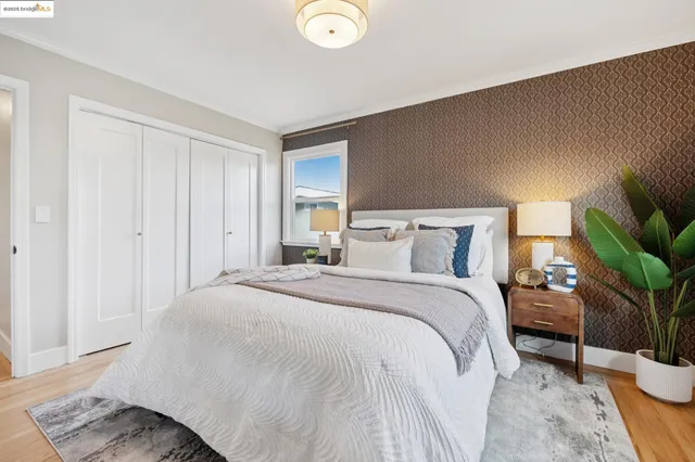 a bedroom with a large bed and a chandelier