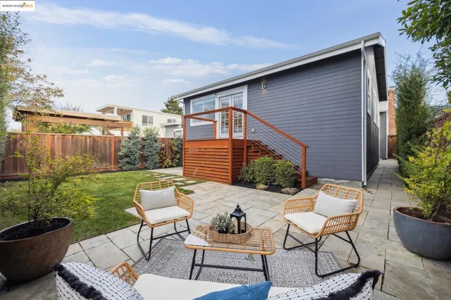 a living room with furniture a fireplace and a large window
