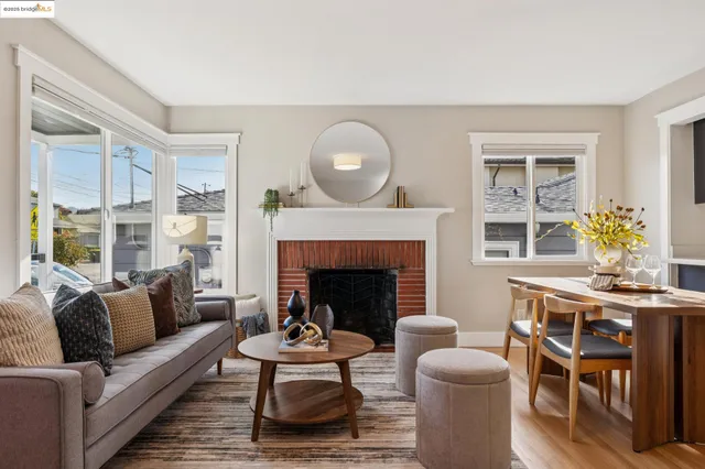a living room with furniture a fireplace and a large window