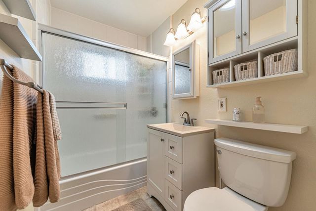 a bathroom with a toilet sink and a shower