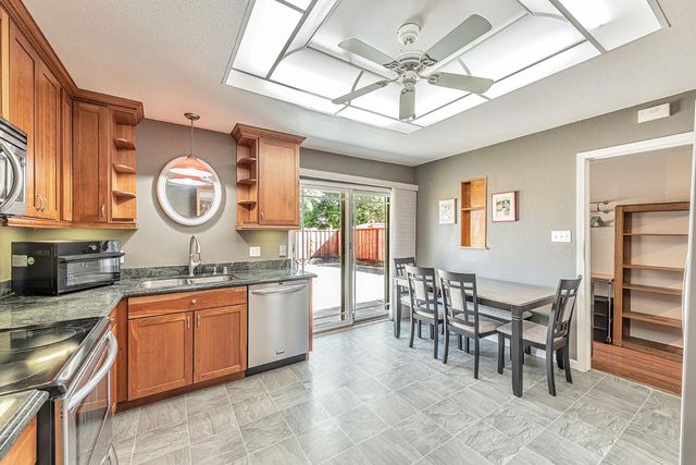 a large kitchen with a table and chairs