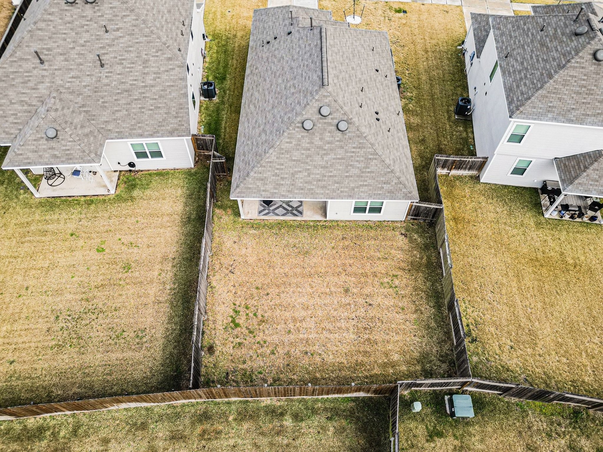 4906 Luke Matthew Drive Rosharon, TX 77583 - Photo 33 of 34 This aerial photo showcases a single-story home with a fenced backyard, nestled between two similar houses. The yard is spacious and well-defined, providing privacy and outdoor space.