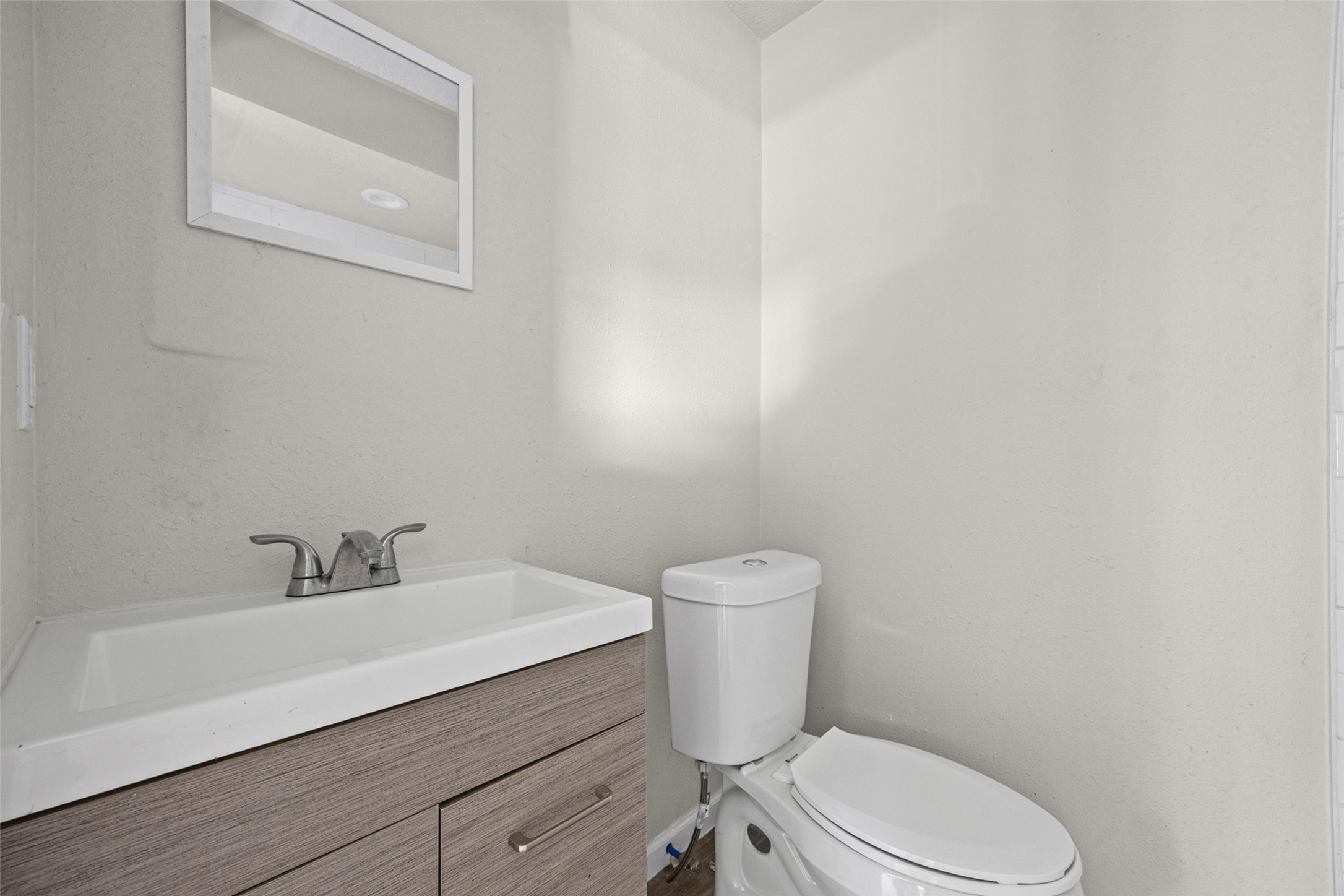 1531 Lahn Road New Braunfels, TX 78130 - Photo 8 of 33 A modern vanity with a sleek chrome faucet pairs perfectly with clean neutral walls.