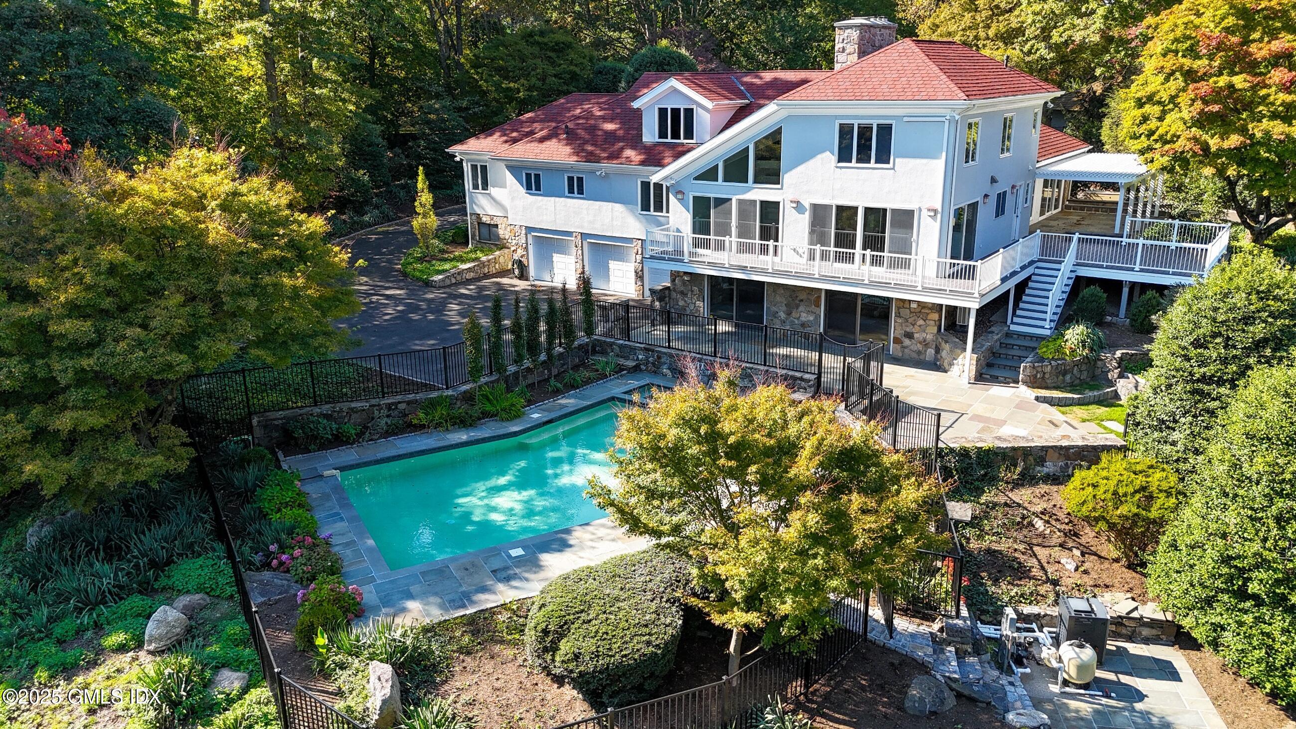 21 Harkim Road Greenwich, CT 06831 - Photo 1 of 40 a front view of a house with a yard and potted plants