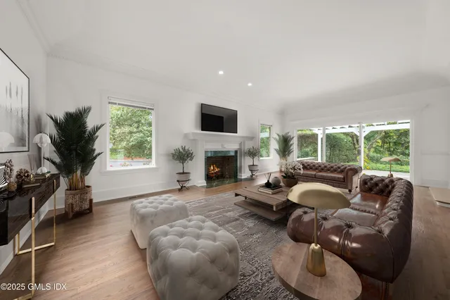 a dining room with furniture and a large window