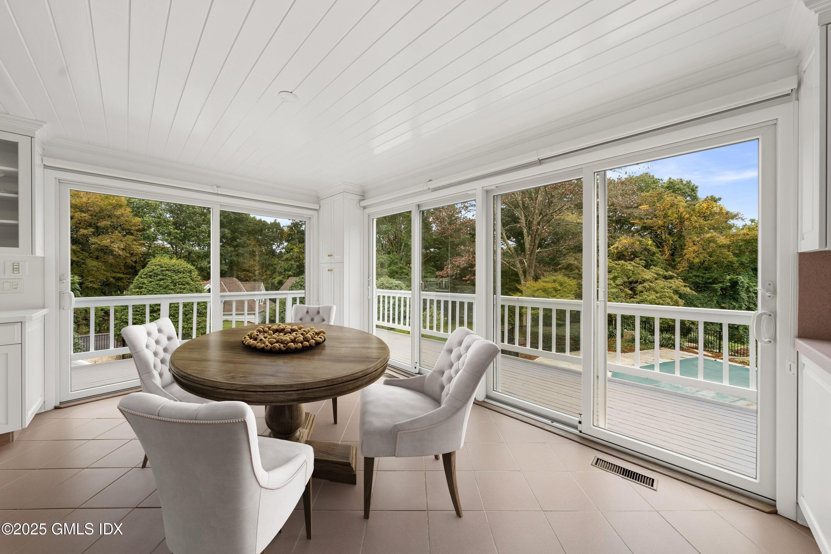 21 Harkim Road Greenwich, CT 06831 - Photo 12 of 40 a dining room with furniture and a large window